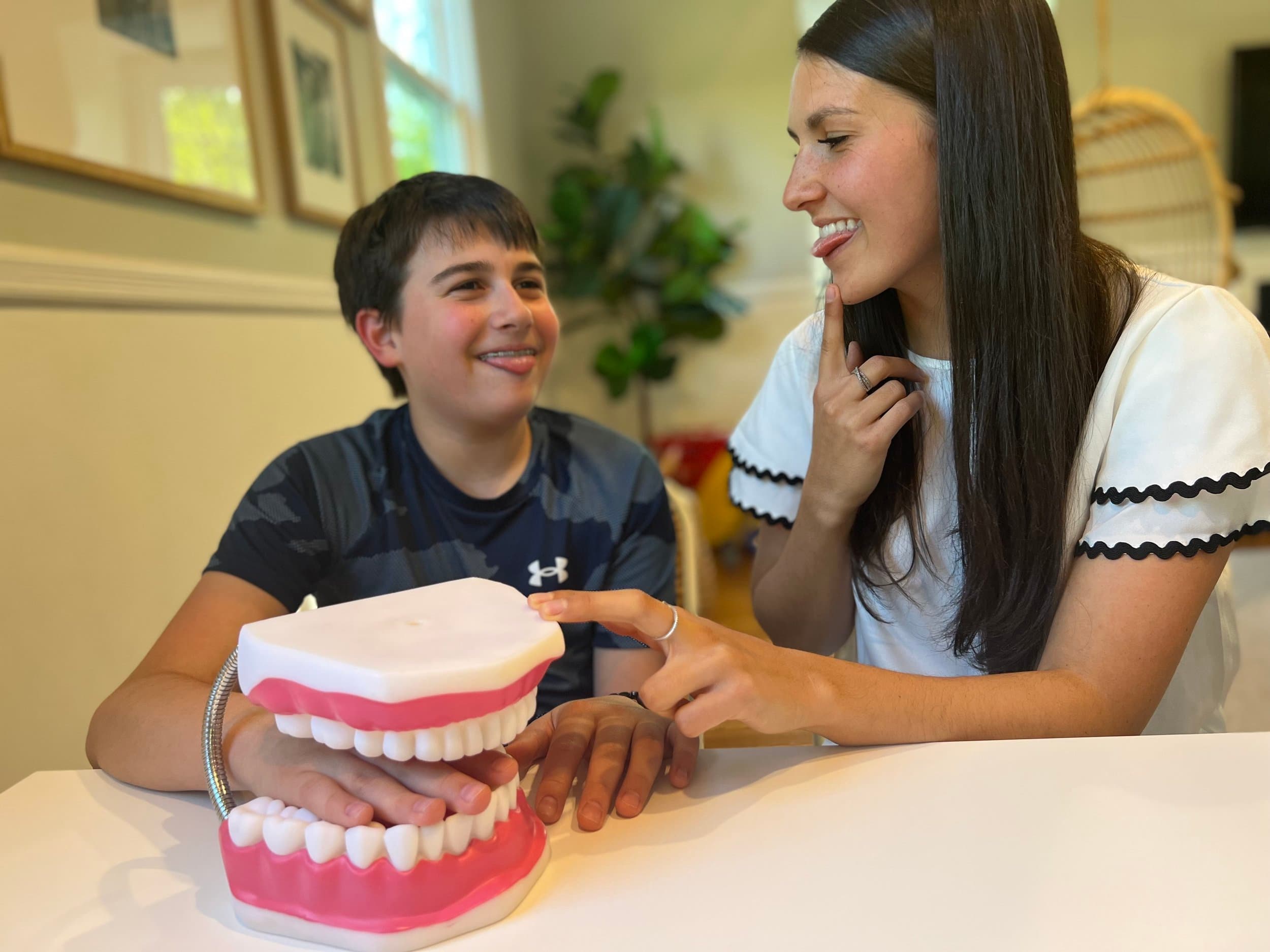 Pediatric speech-language pathologist working one-on-one with a child during an in-home speech therapy session in Fairfield County, CT